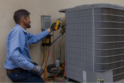 An air conditioning and heater repair technician - Streamline Heating and Air A Sarasota heater repair technician plugging in plugs into an outdoor air conditioner