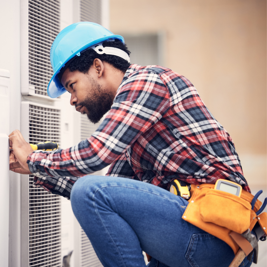 A worker completing an A/C installation and working on improving indoor air quality
