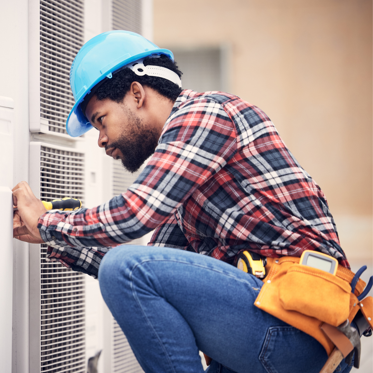 A worker completing an A/C installation and working on improving indoor air quality