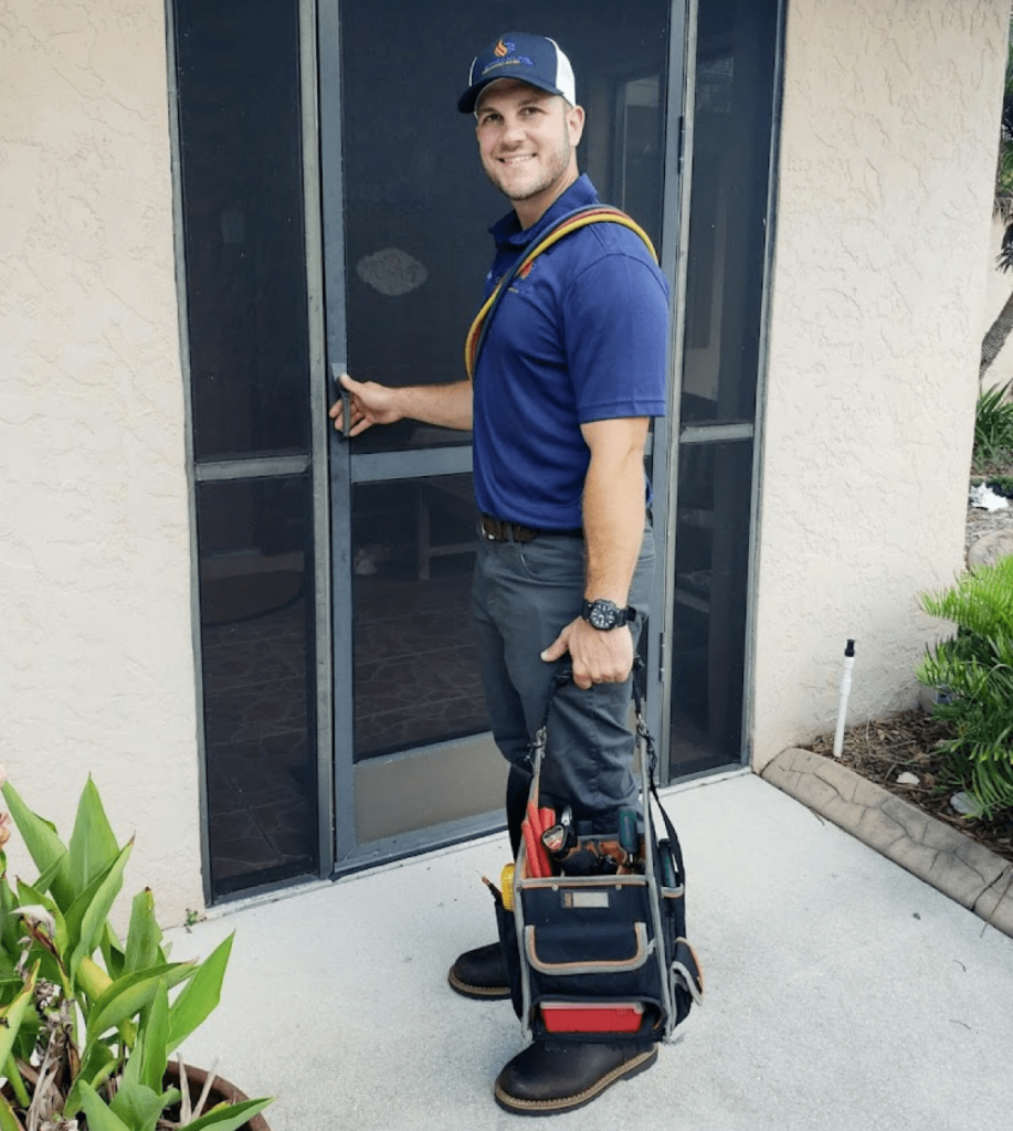 Clayton Burkhardt, founder of Streamline Heating and Air, smiling while opening a door to a building