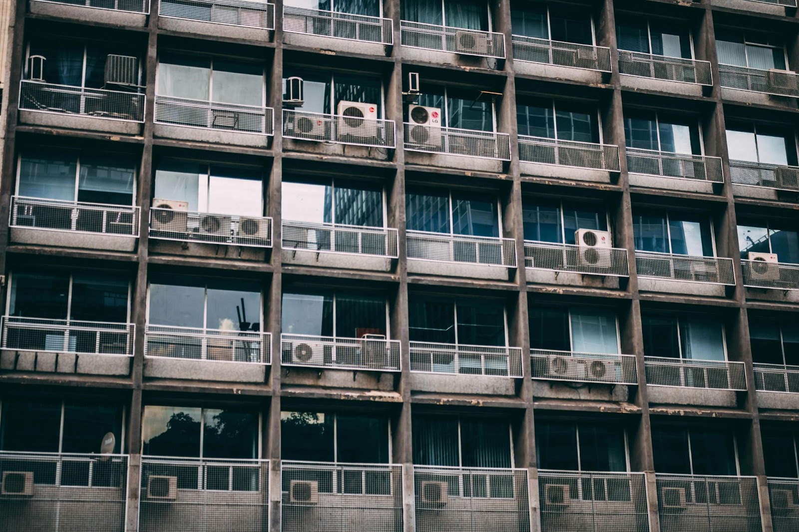Building with balcony and several air conditioners