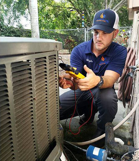 A picture of an HVAC professional working on an outdoor air conditioner not turning on