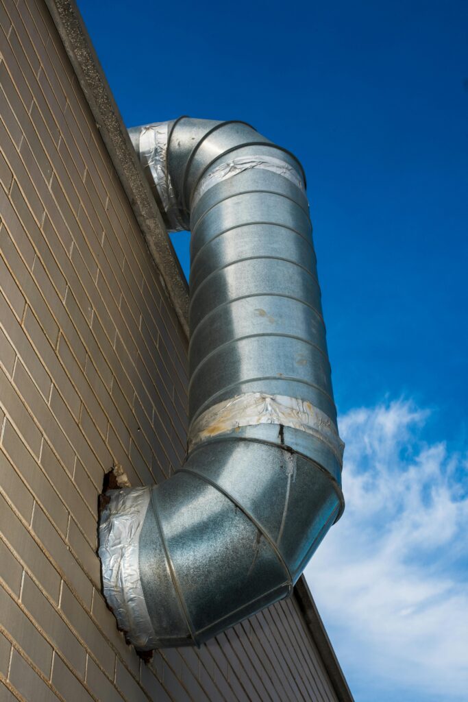 A picture of a new HVAC air duct on the outside of a building