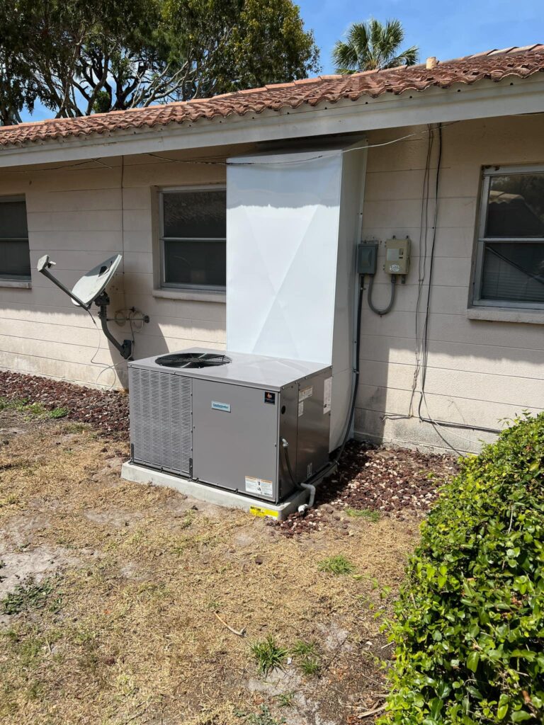 Outdoor air conditioner against a wall