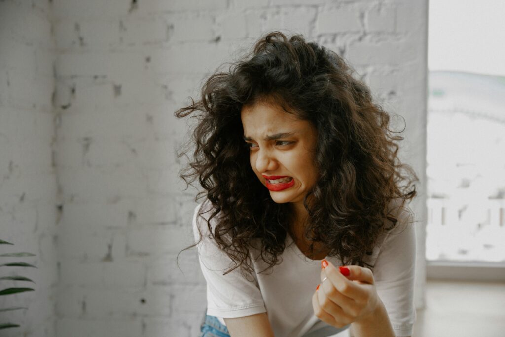 Woman looking like she smelled something gross